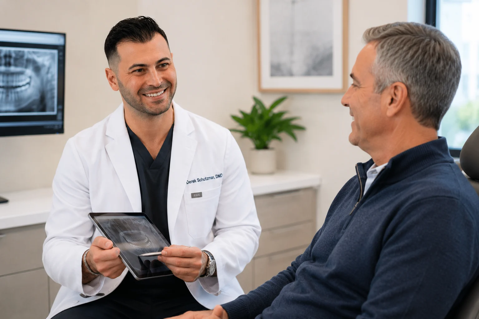 Derek Schutzman DMD with patient explaining