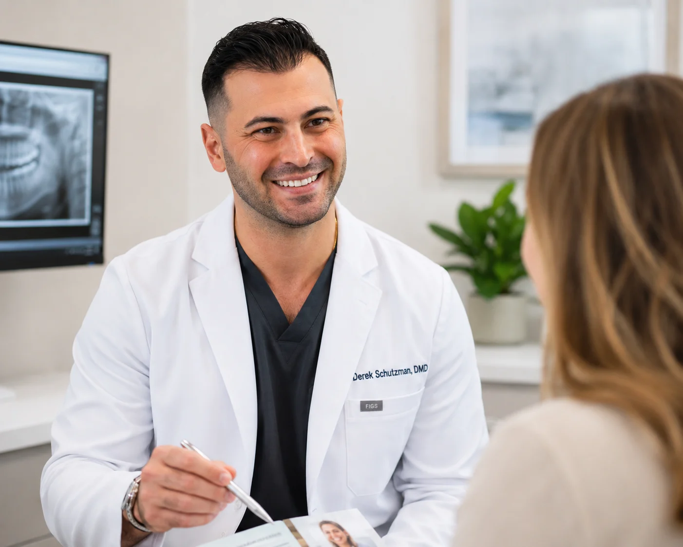 Derek Schutzman DMD with patient explaining in SEDA dental Boynton beach