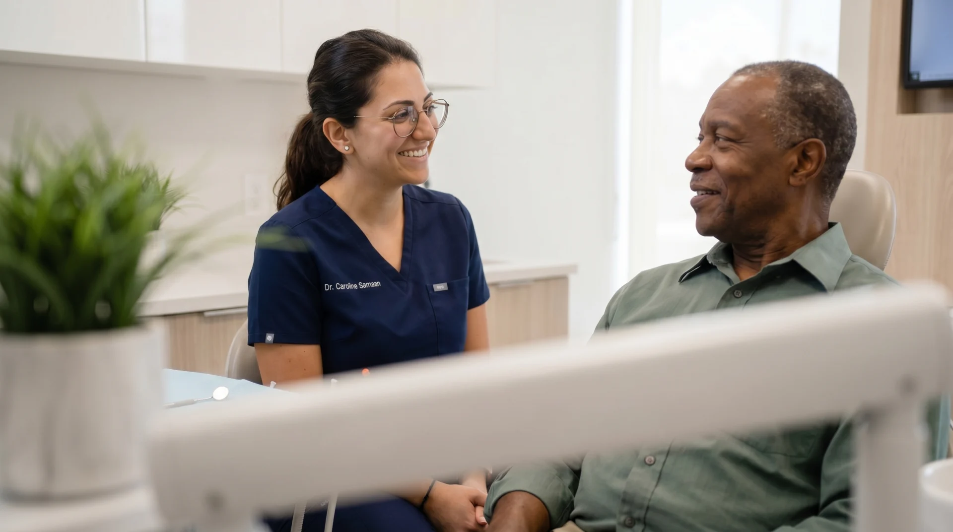 Dentist and patient smiling together