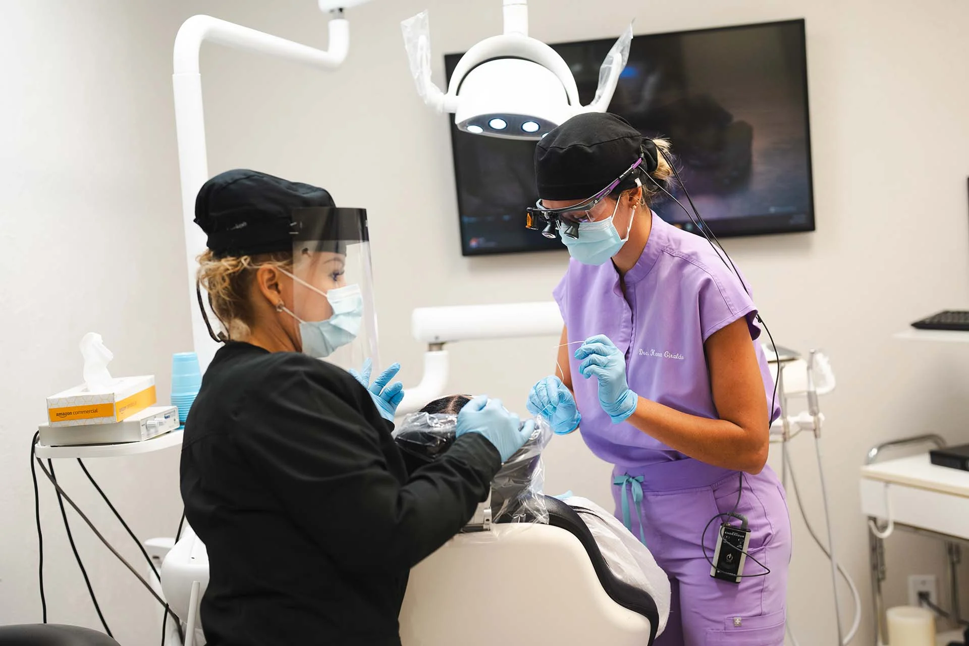 Dental professionals working on patient