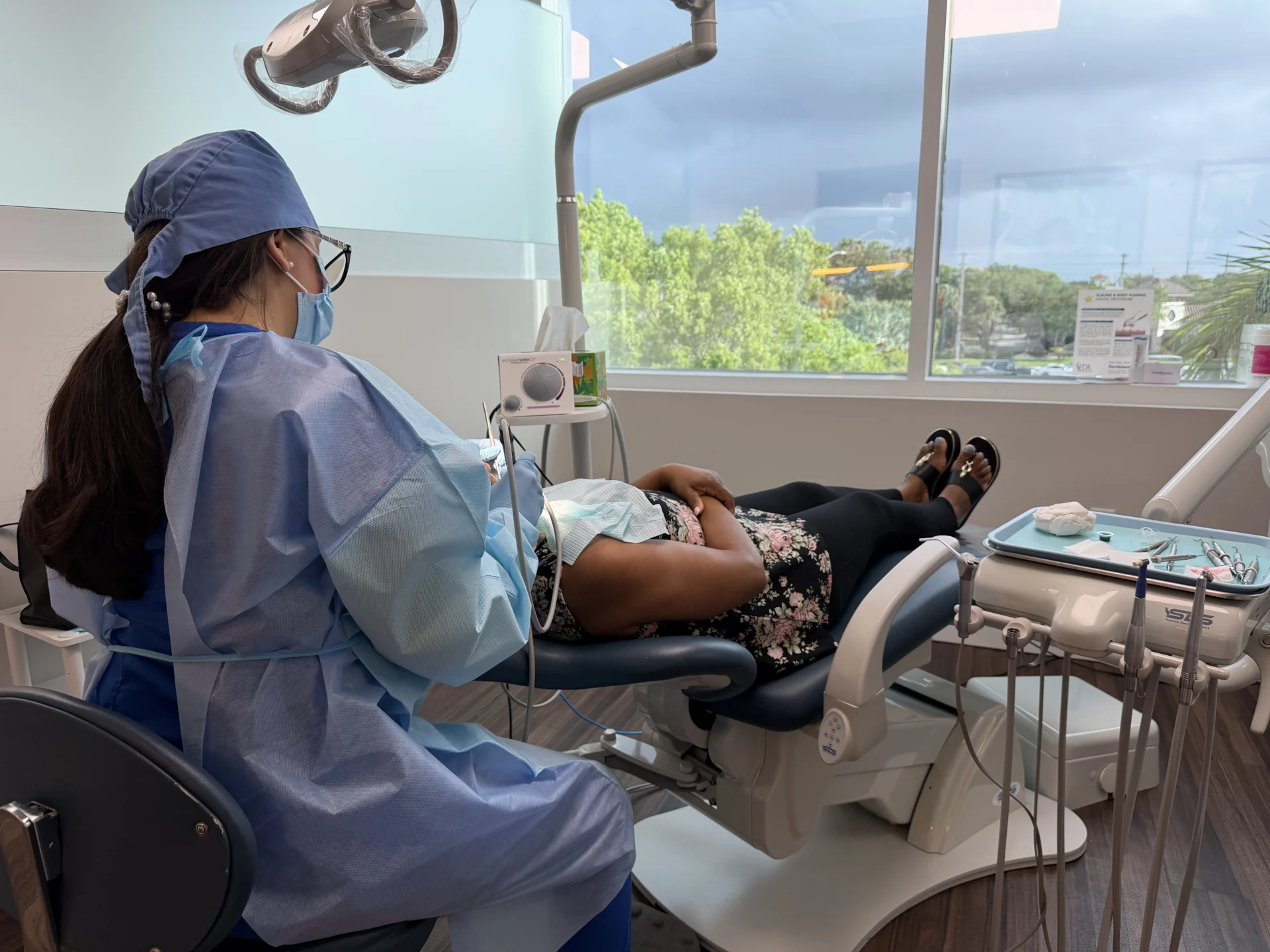 Patient in dental chair with dental hygienist