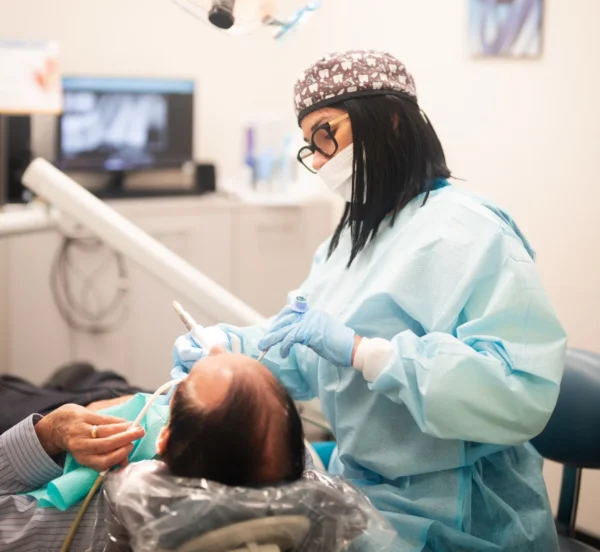 Dental Hygienist performing a teeth cleaning in SEDA dental