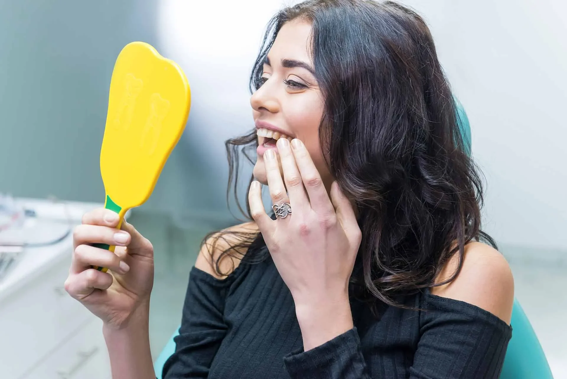 Women smiling about her dental implant